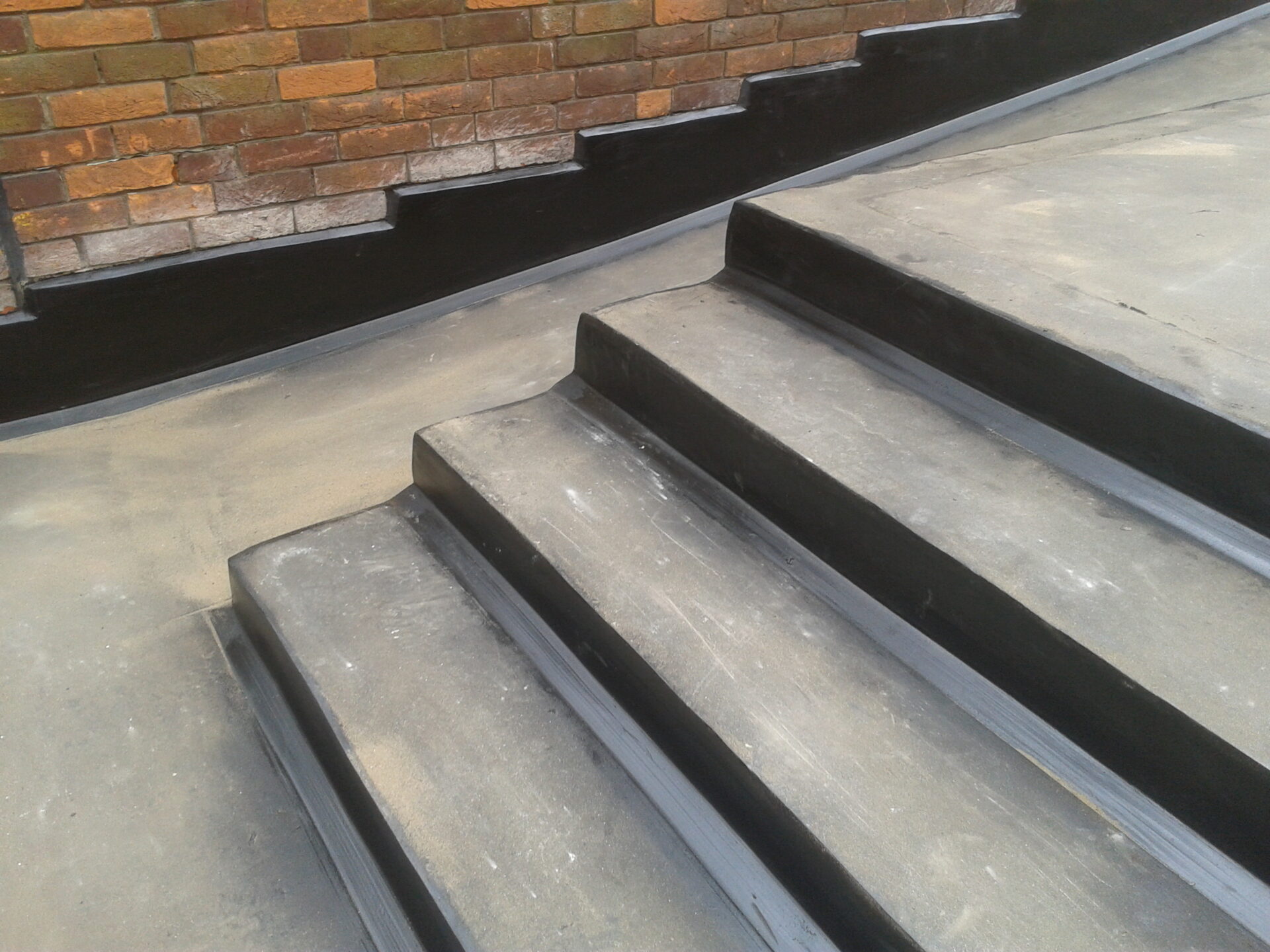 Newly laid roofing with steps alongside.